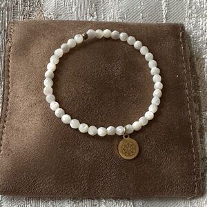Elegant White Beaded Bracelet with Gold Sister Charm